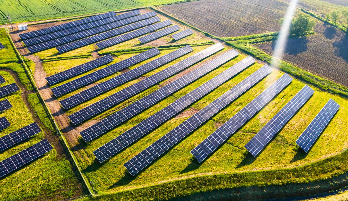 Aerial view of a ground-mount solar farm in open agricultural land