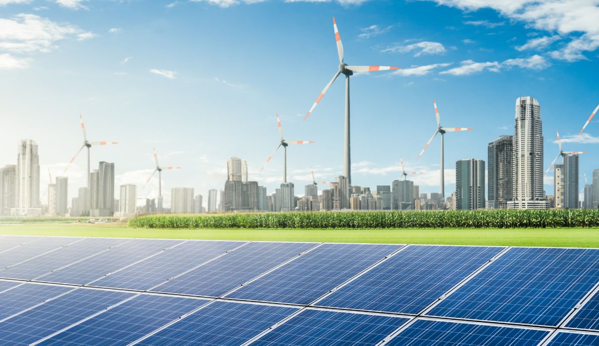 Row of solar panels on grass against blue sky